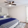 a bedroom with a bed and a fan