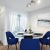 a living room with blue chairs