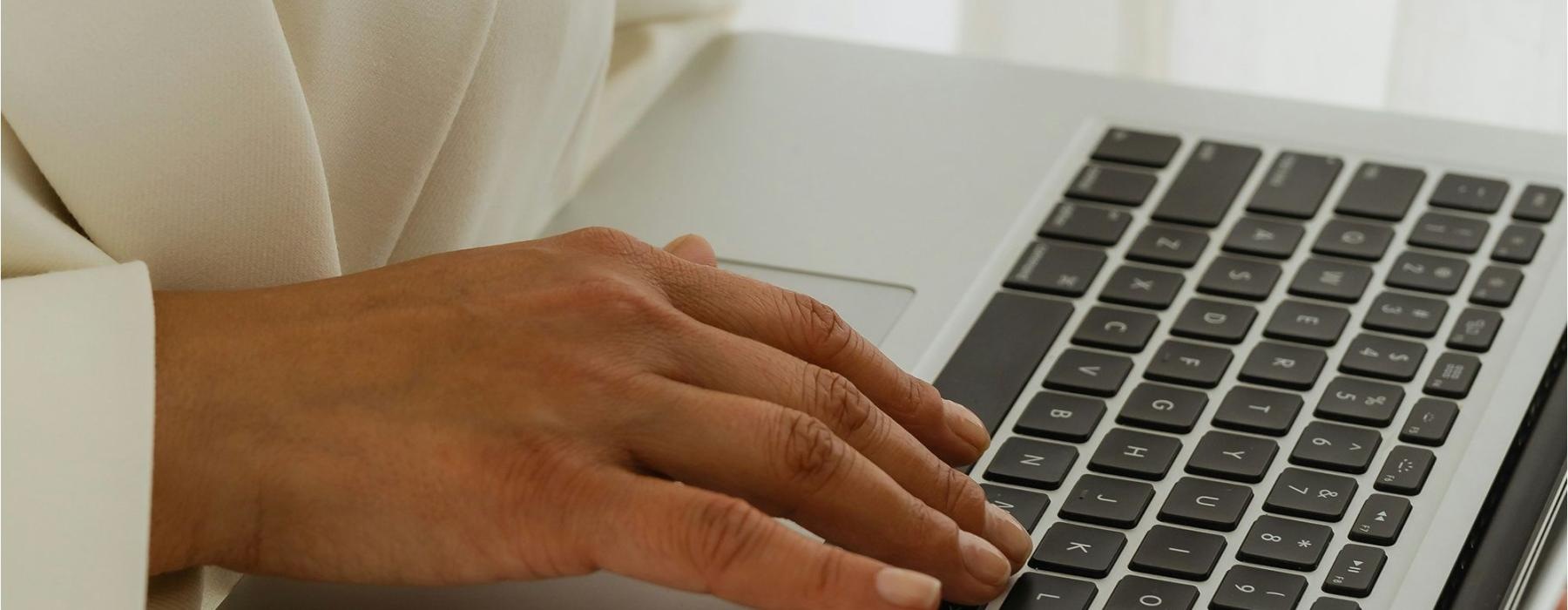 a person typing on a laptop