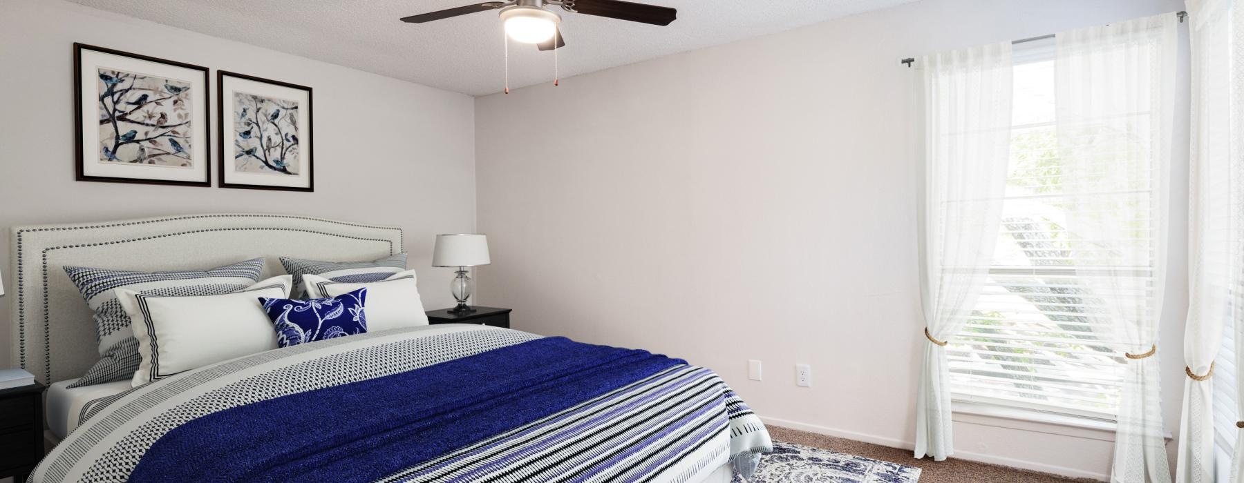 a bedroom with a bed and a fan